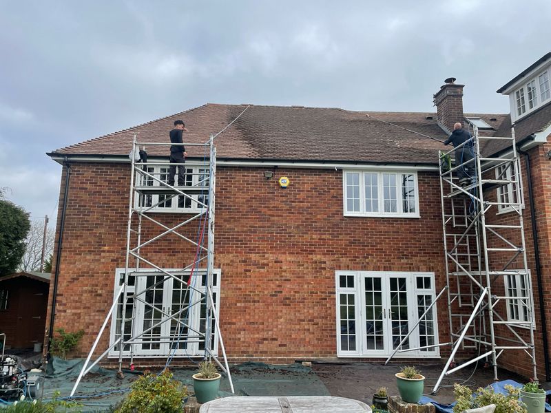 Roof cleaning carried out safely from scaffold towers by The Roof Moss Cleaners in Biggleswade